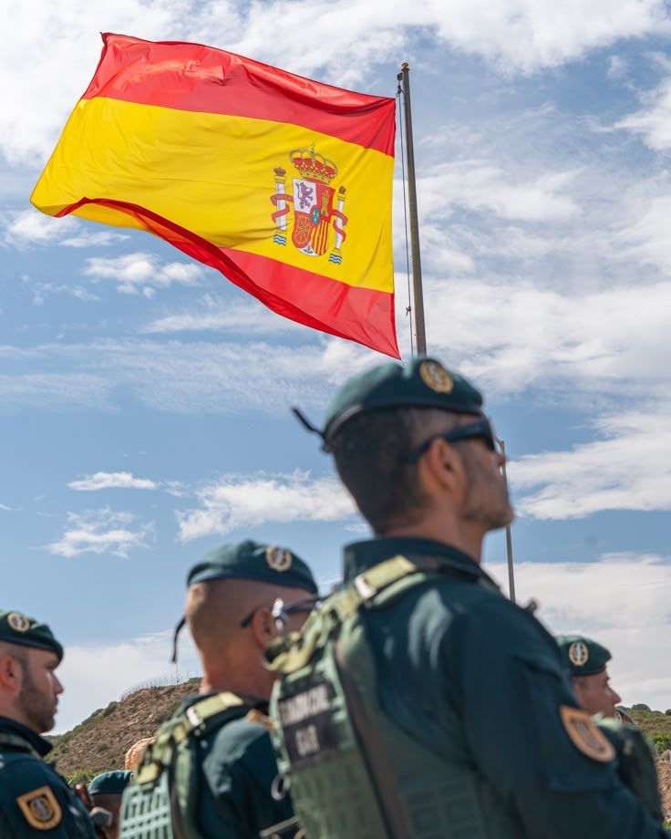 Agentes de la Guardia Civil bajo la bandera de España